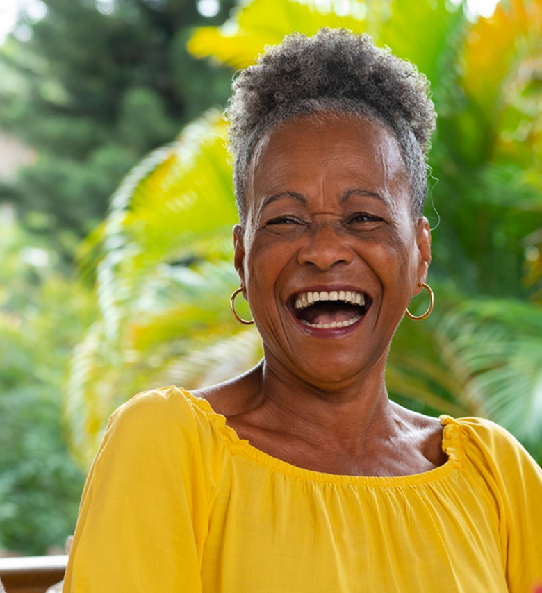Person smiling wearing yellow shirt